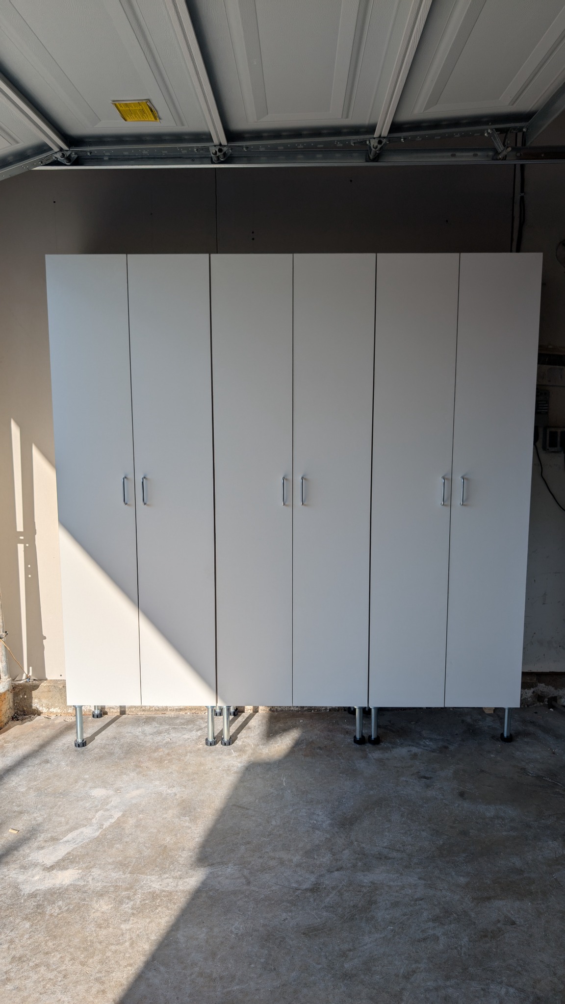 White melamine garage cabinet bank for clean storage.
