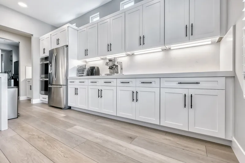White built‑in cabinets with stainless appliances