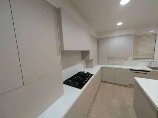 Soft-close pull-out drawer interior showing custom cabinet construction