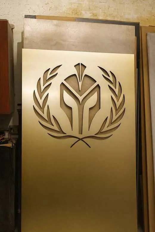 Custom CNC-carved wood emblem panel showcasing precision cutting