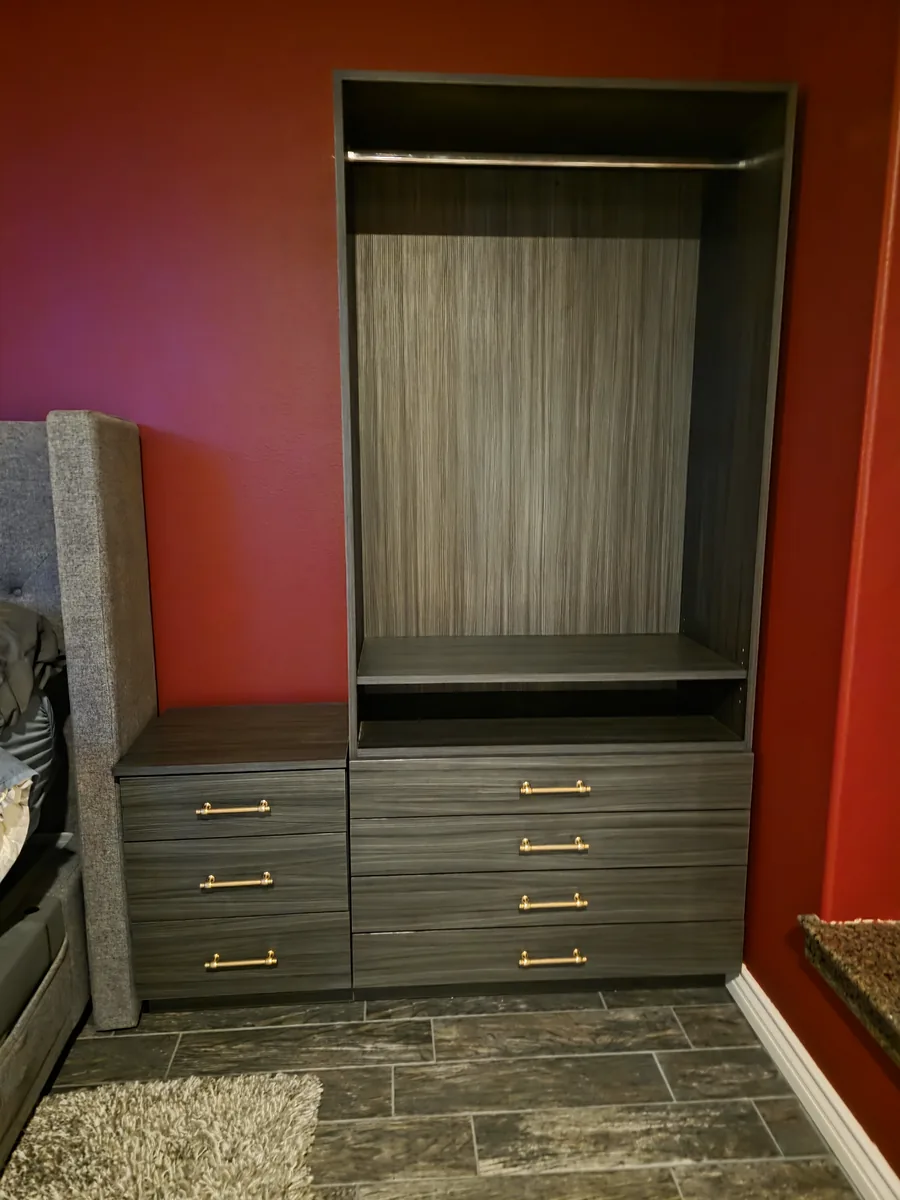 Custom gray wood-grain wardrobe tower and matching nightstand with brushed gold drawer pulls