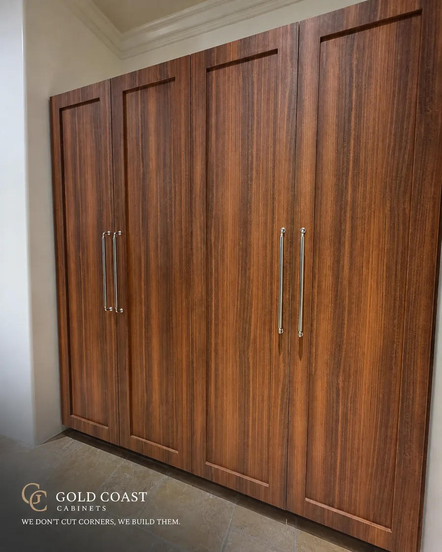 Custom walnut-tone Shaker tall cabinet doors with polished nickel appliance pulls