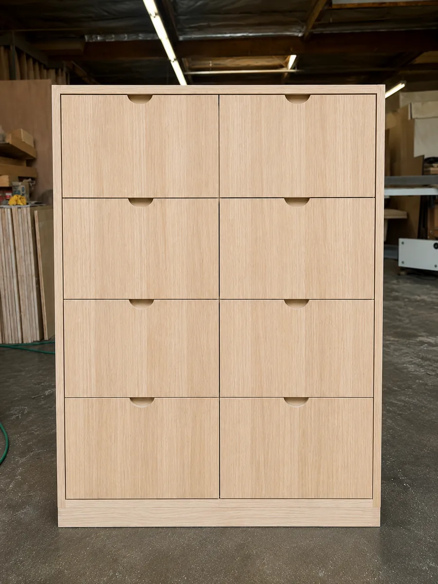 Custom white oak eight-drawer chest with finger-pull cutouts, photographed in the Gold Coast Cabinets shop
